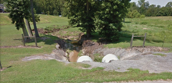 photograph of two concrete culvers draining into a stream