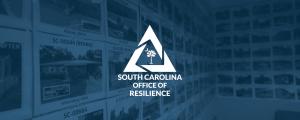 Photographs of repaired and rebuilt houses hanging on a conference room wall with the SC Office of Resilience logo overlayed